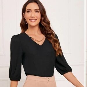 Black puff sleeve blouse with gold chain detail